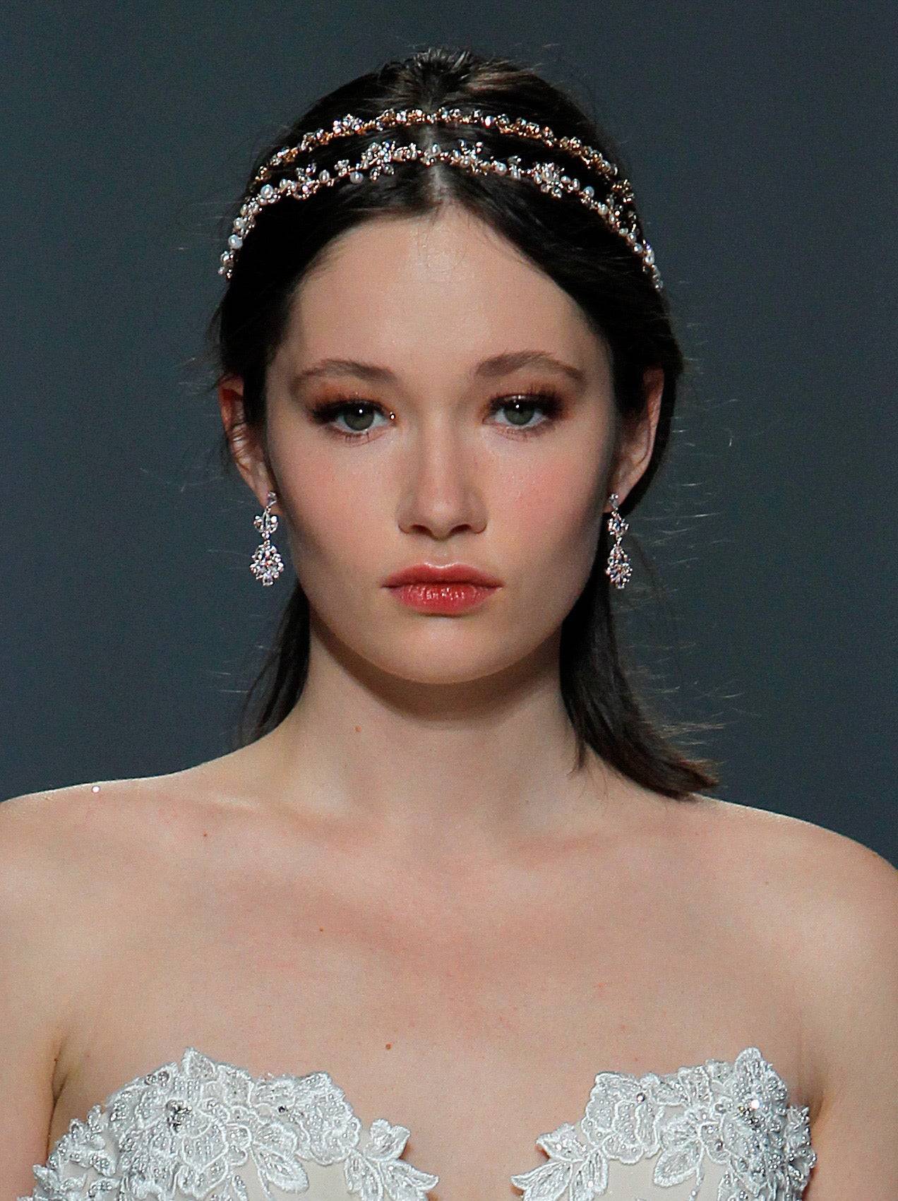 Freshwater pearl bridal headband with crystals in silver, elegantly worn by a model. Perfect wedding headpiece for timeless bridal style.