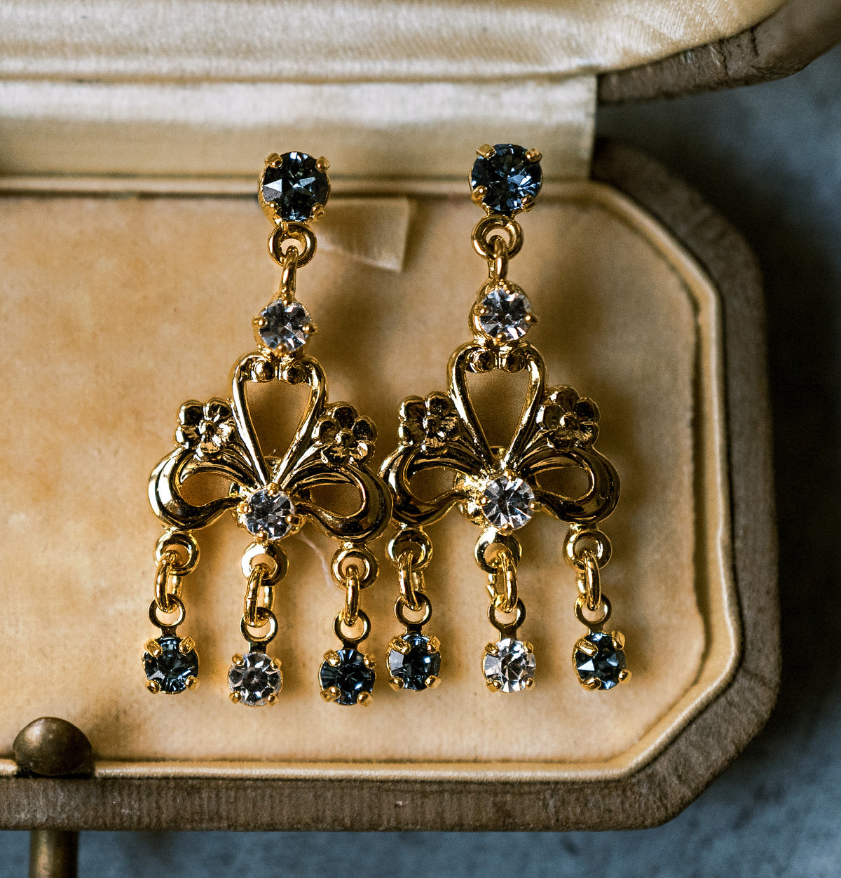 Detail of the Martha Chandelier Earrings, gold scroll chandelier drops with French blue crystals inspired by Martha Washington's shoe buckles, holiday statement earrings | EDEN LUXE Bridal