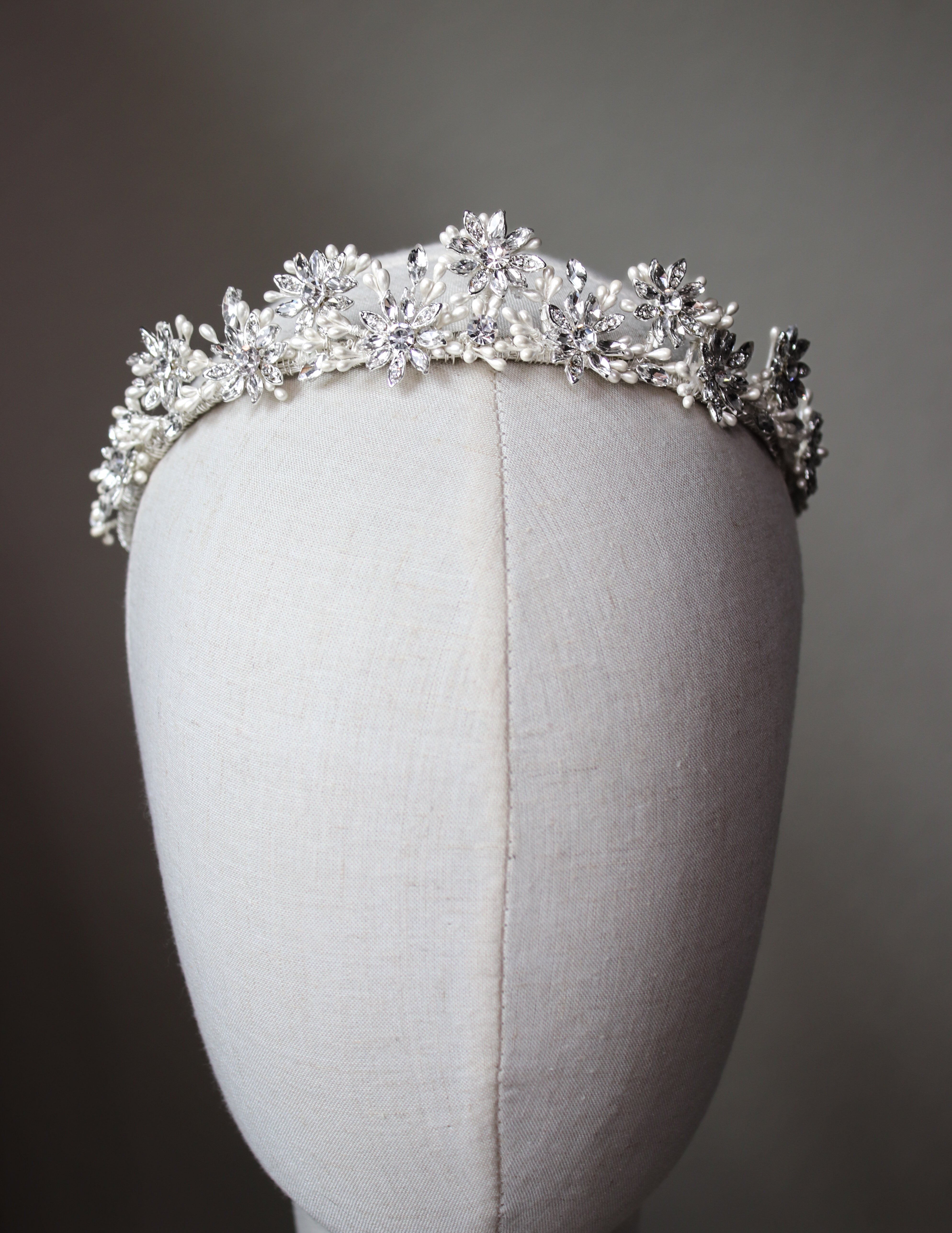Close-up of Etoiles en Chantilly Crown’s lace-like filigree and shimmering crystals in silver-tone finish by EDEN LUXE Bridal.