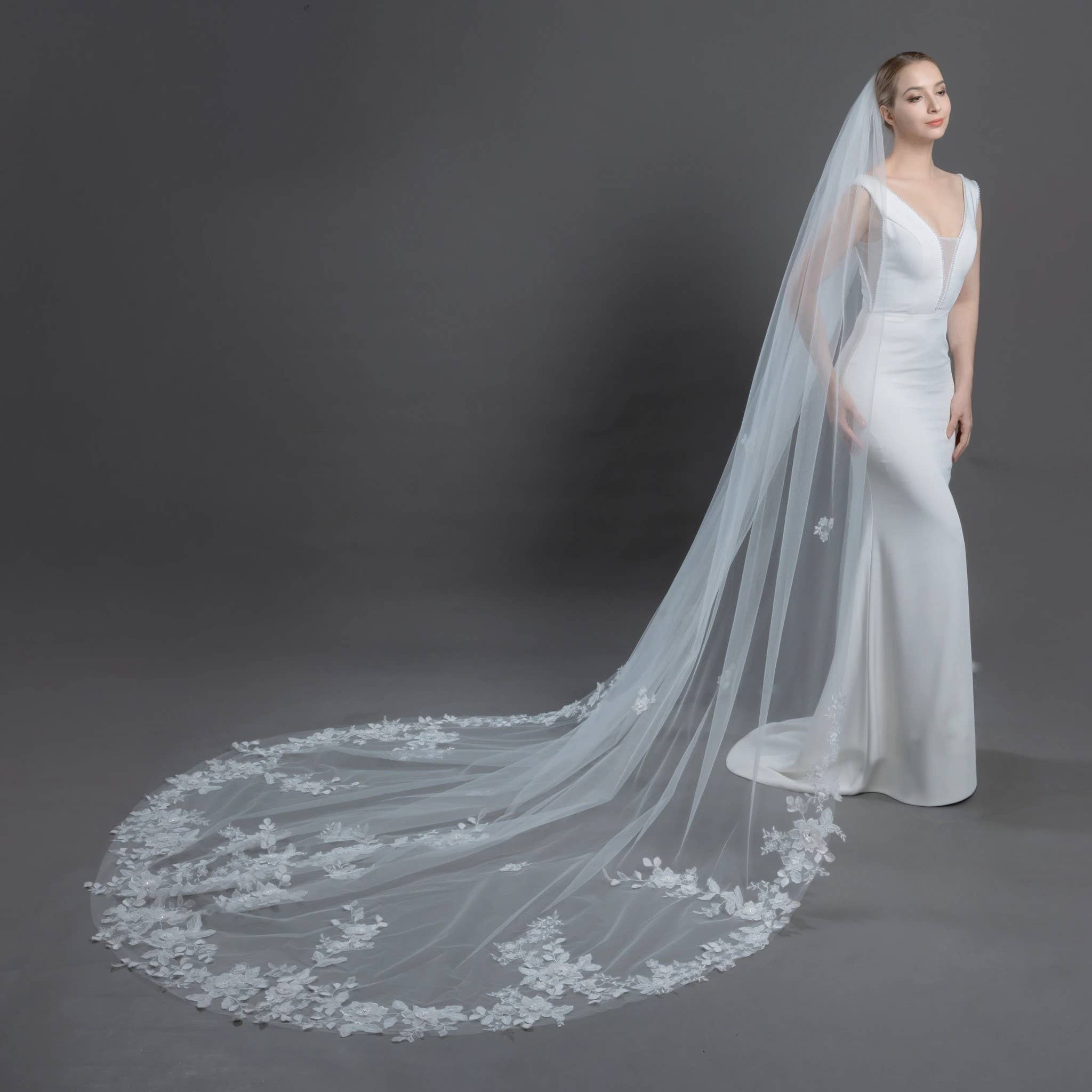 ELLINA veil draped over luxury wedding gown, highlighting sheer tulle, expansive width, and romantic floral embroidery| EDEN LUXE Bridal