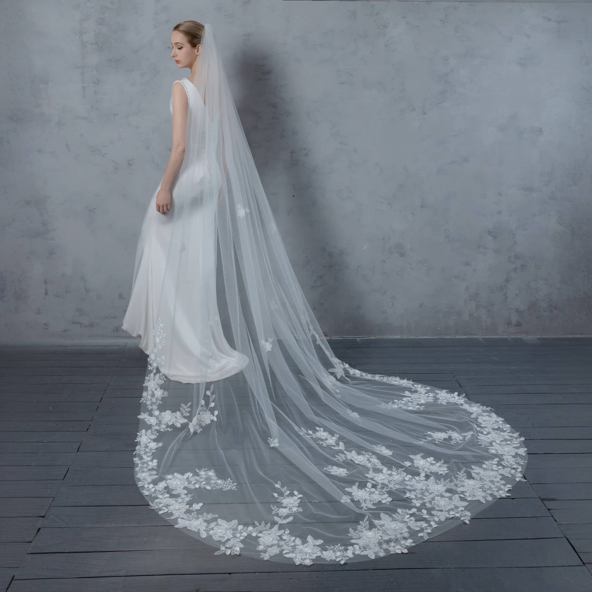 Bride wearing wide cathedral veil in pale ivory bridal illusion tulle with 3D organza flowers. | EDEN LUXE Bridal