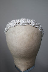 Front view of the CLARISSA bridal headband with shimmering crystal and pearl accents in a floral motif on a silver base.