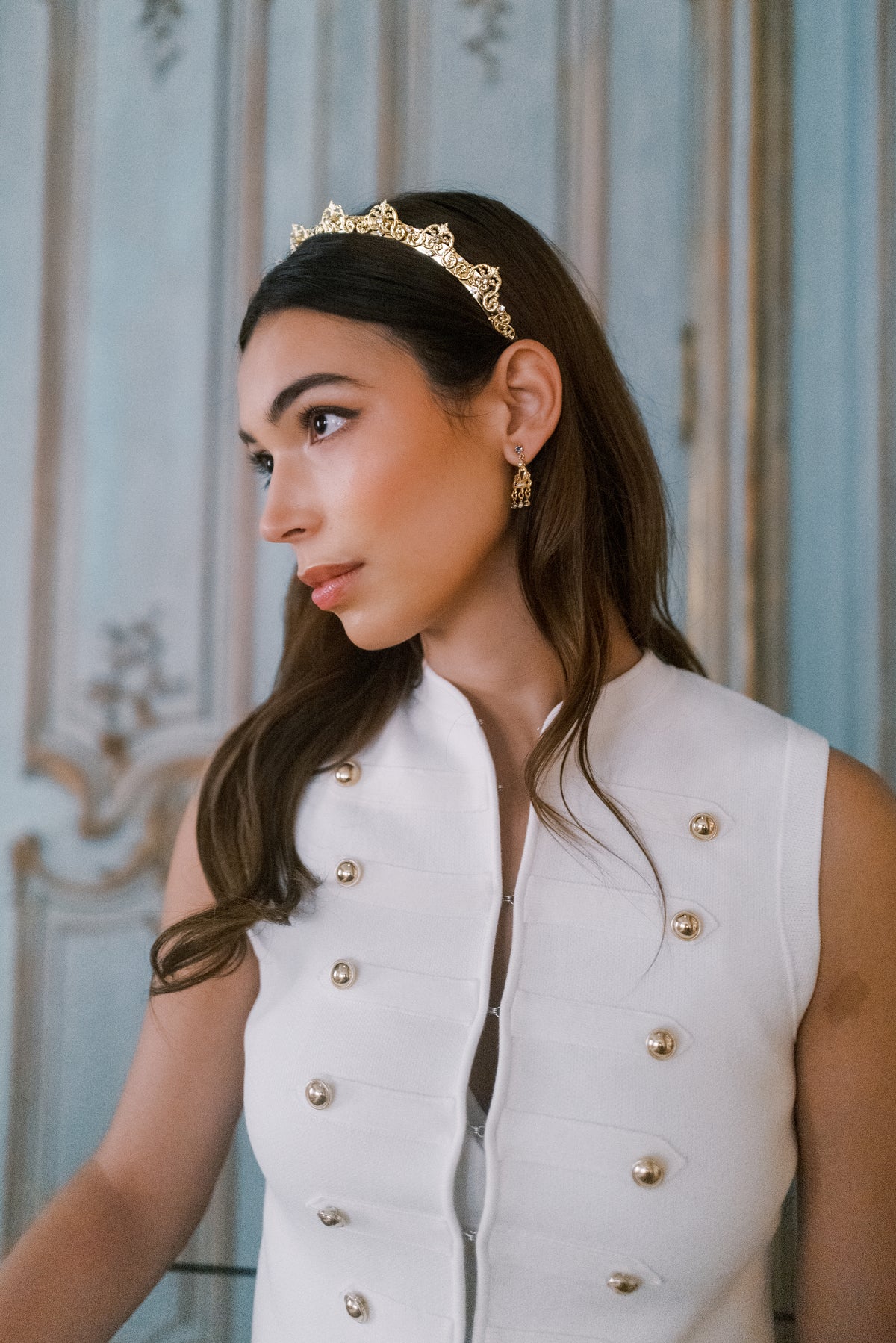Model wearing the Antoinette Halo, a 14k gold plated French Rococo Swarovski crystal headband, in a French period room at The Metropolitan Museum of Art, Sophie Kaye x EDEN LUXE Revolution Collection | EDEN LUXE Bridal