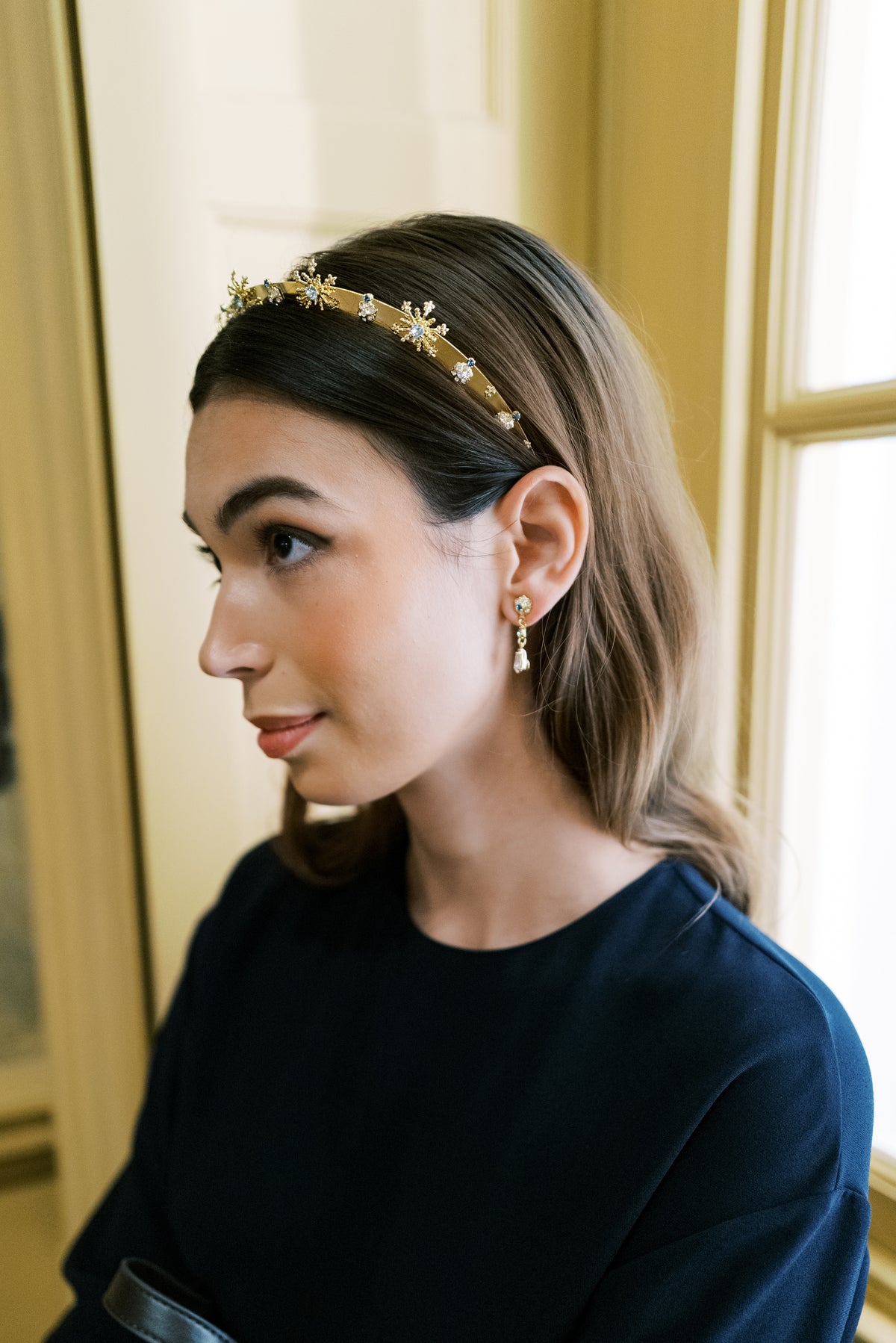 Profile of the Madame Brillon French blue crystal fireworks headband with drop earrings by a gallery window at The Metropolitan Museum of Art, Sophie Kaye x EDEN LUXE Revolution Collection | EDEN LUXE Bridal