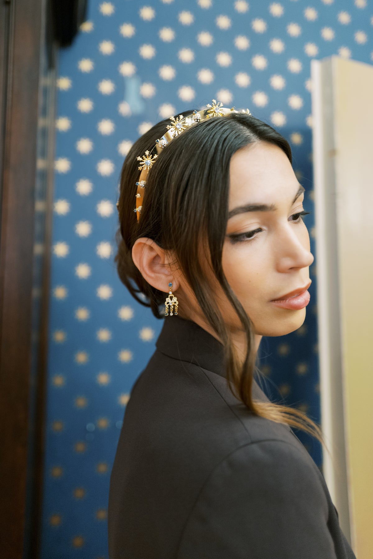 Model wearing the Madame Brillon fireworks headband and drop earrings in a black blazer at Fraunces Tavern in New York City, Sophie Kaye x EDEN LUXE Revolution Collection | EDEN LUXE Bridal