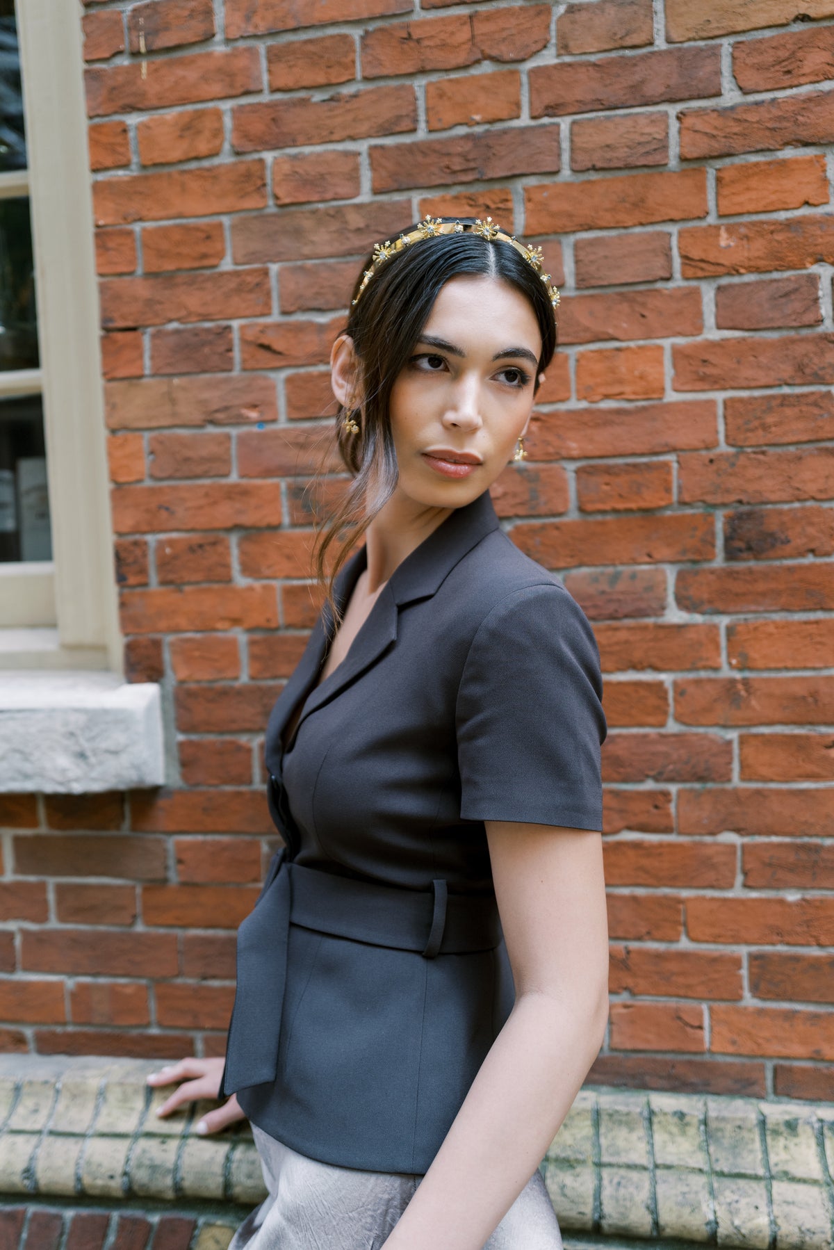Madame Brillon fireworks headband worn with a black blazer against the historic brick of Fraunces Tavern, New York, elevated everyday tiara by Sophie Kaye x EDEN LUXE | EDEN LUXE Bridal