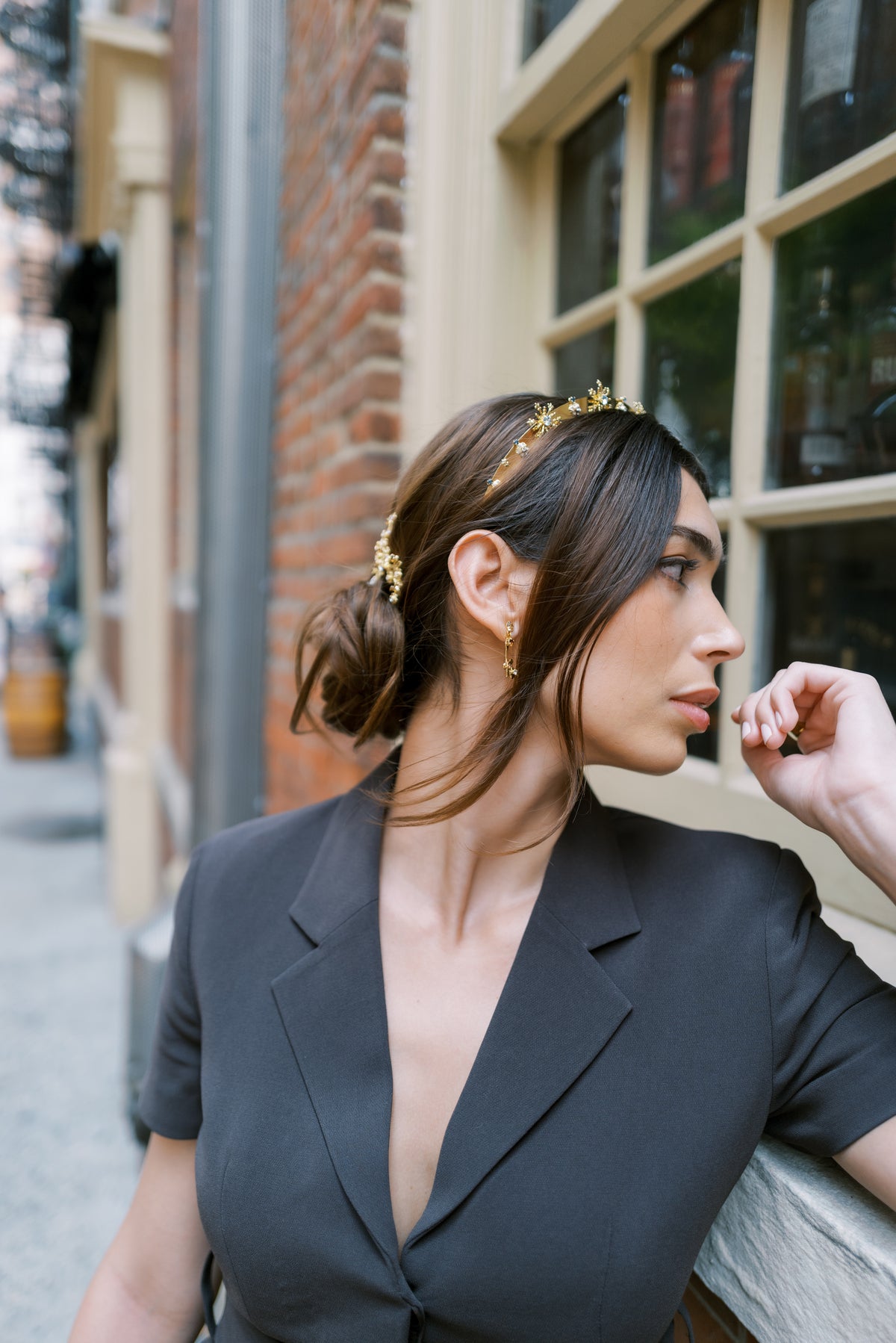 Madame Brillon Everyday Tiara worn with a low bun and drop earrings outside Fraunces Tavern in Lower Manhattan, gold crystal headband for New Year's Eve and holiday parties | EDEN LUXE Bridal