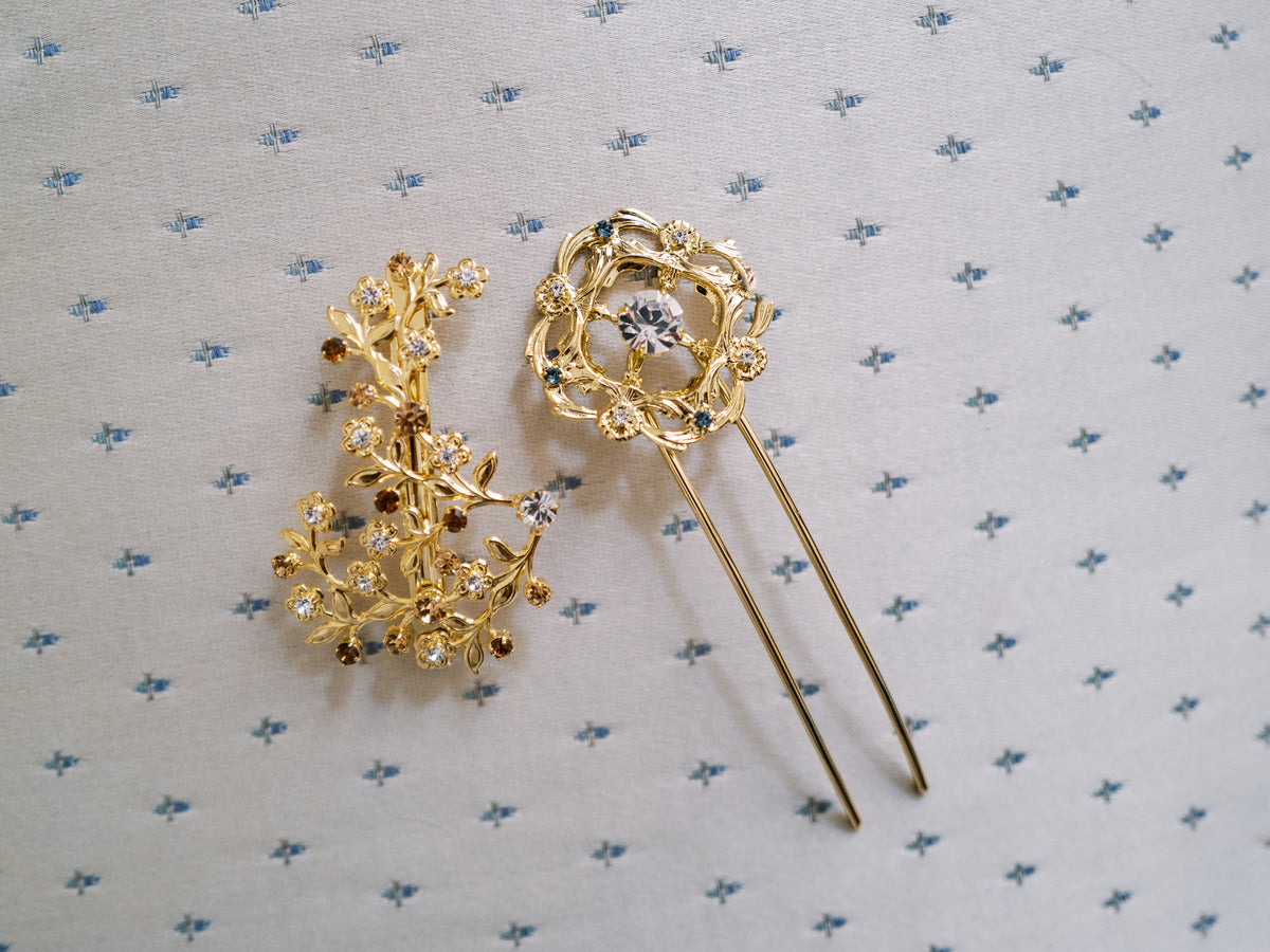 Martha Hairpin, a 14k gold plated clear and French blue Swarovski crystal hair pin inspired by Martha Washington's 18th-century shoe buckles, shown with a coordinating floral piece | EDEN LUXE Bridal