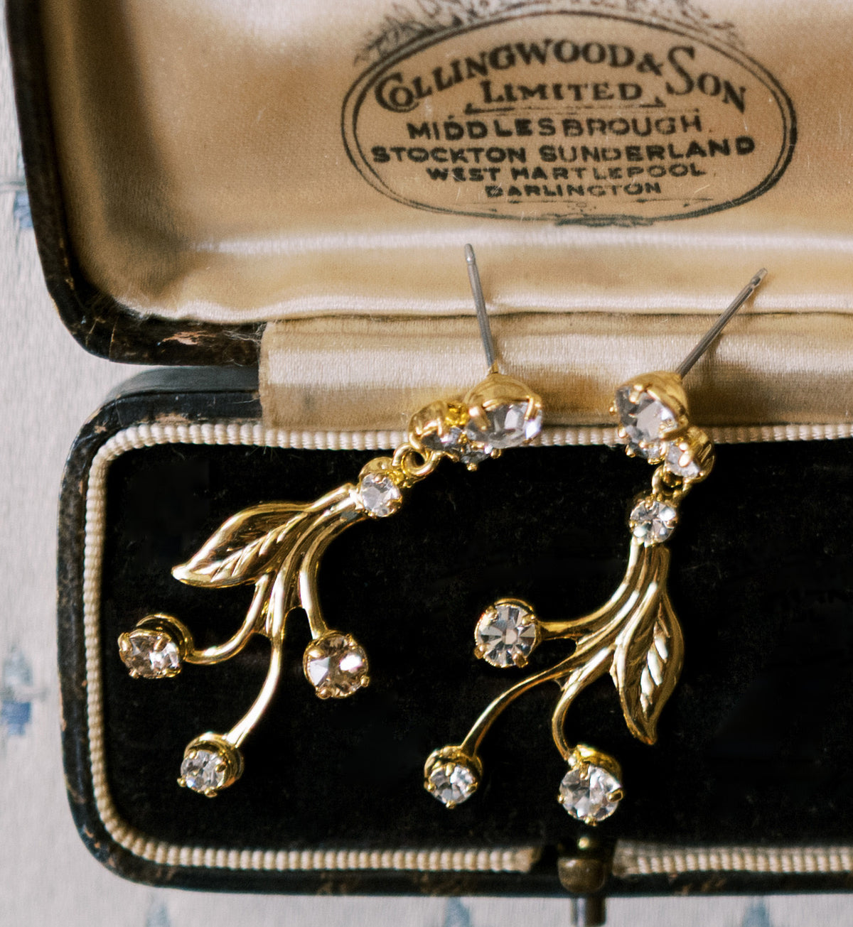 Wheatley Earrings, 14k gold plated vine drop earrings with clear Swarovski crystals, in an antique jeweler's box, Sophie Kaye x EDEN LUXE Revolution Collection | EDEN LUXE Bridal