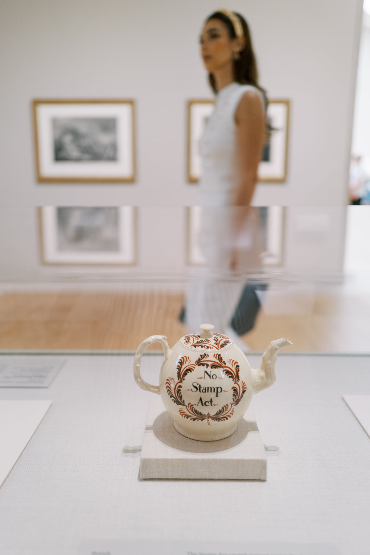 Model wearing the Wheatley Halo Everyday Tiara walking past the No Stamp Act teapot at The Metropolitan Museum of Art, Sophie Kaye x EDEN LUXE Revolution Collection gold crystal headband | EDEN LUXE Bridal